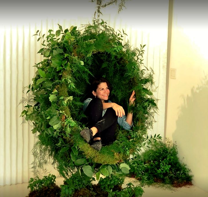 Hanging ring of greenery, ferns and moss large enough to sit inside